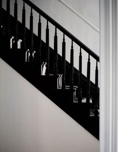 black and white photograph of stair railings with handrails on the bottom floor