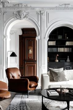 a living room filled with furniture and bookshelves