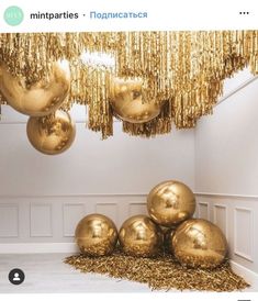 some gold balloons are hanging from the ceiling