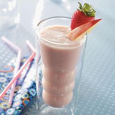 a drink with strawberries on the top and two drinking straws next to it