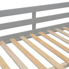 a close up of a bed frame with wood slats