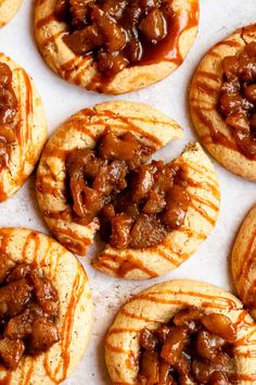 several cookies with caramel toppings are on a baking sheet