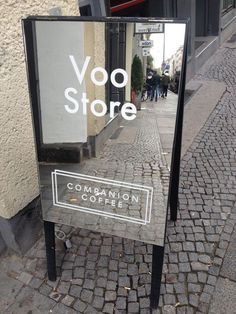 there is a sign that says voo store on the side of the street in front of a building