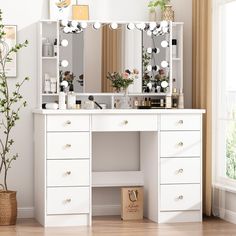 a white dressing table with drawers and mirrors