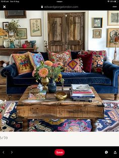 a living room filled with furniture and lots of pillows on top of the couches