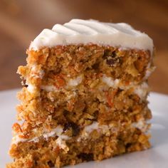 a slice of carrot cake with white frosting on a plate