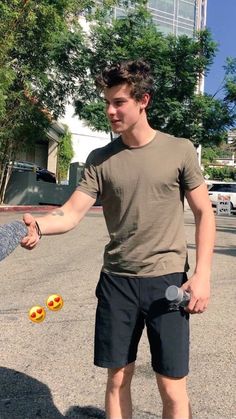 a young man is holding onto his skateboard