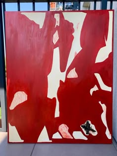 a painting with red and white paint on it