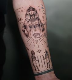 an egyptian tattoo on the arm