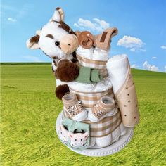 a stuffed giraffe sitting on top of a pile of diapers in the grass