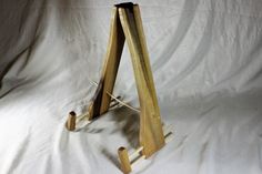 a wooden easel sitting on top of a white sheet