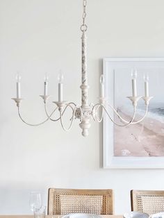 a chandelier hanging from the ceiling in a dining room