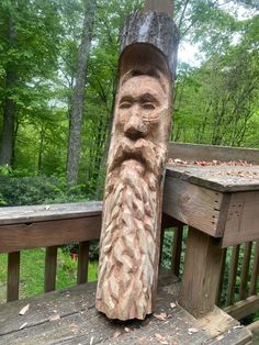 a wooden carving of a bearded man on a deck