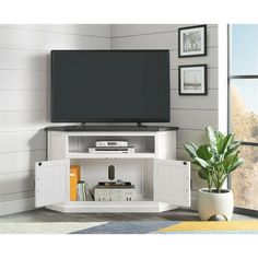 a flat screen tv sitting on top of a white entertainment center