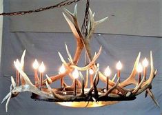 a chandelier with deer antlers and candles