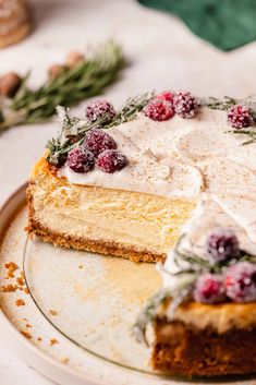 a cake with white frosting and cranberries on top sitting on a plate