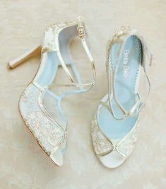 two pairs of wedding shoes are shown on the floor