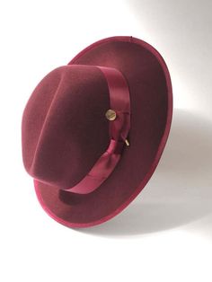 A timeless chic Trilby featuring a tonal satin hat band and inner petersham ribbon. Handcrafted in wool felt with a wired brim for fashioning to suit. Maximum size 57cm. Inside adjuster for one size fits all. Elegant Fedora With Curved Brim For Fall, Elegant Curved Brim Fedora For Fall, Elegant Fall Fedora With Curved Brim, Classic Fall Formal Cloche Hat, Elegant Fur Felt Panama Hat For Fall, Elegant Adjustable Panama Hat For Fall, Elegant Flat Brim Panama Hat For Fall, Elegant Formal Hat For Fall, Elegant Formal Fall Hat