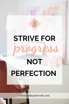 a desk with a laptop on it and the words, strive for progress not perfection