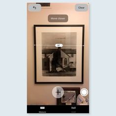 a photo hanging on the wall in front of a mirror with an arrow pointing to it