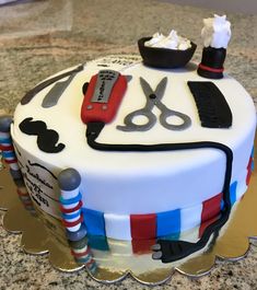 a cake decorated with scissors and other items