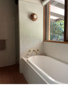 a white bath tub sitting next to a window