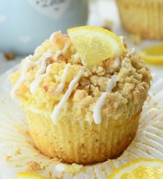 a muffin with lemons and icing on top sitting on a paper plate