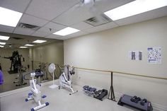 a gym with exercise equipment and mirrors