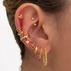 a close up of a person's ear with three different types of piercings