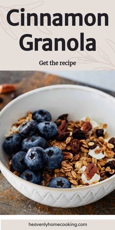 a bowl filled with granola and blueberries