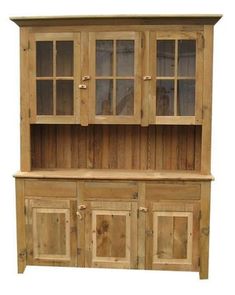 a wooden hutch sitting in the grass