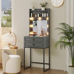 a grey vanity with lights on it next to a chair and potted plant in the corner