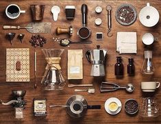 a table topped with lots of different types of kitchen utensils and coffee cups