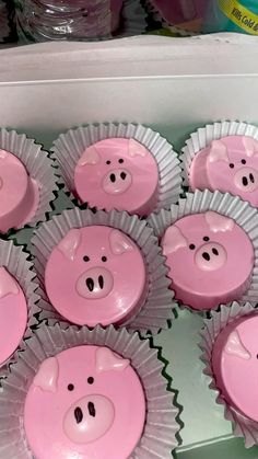 cupcakes with pink frosting and pig faces are in the shape of pigs