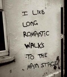 graffiti on the side of a building that says i like long romantic walks to the main stage