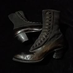 "This is a pair of Genuine Black leather Antique boots from the Victorian era., approx 1890's - 1900.   The boots are black leather foot with black fabric top including all of the original buttons! Wood stacked 1 3/4 inch heels.   These are a very small size and serve as more of a display piece. Or maybe to fit a child. I think the handwritten numbers and letters inside say size \"3 B\". Approx. 8 3/4 - 9 inches from toe to heel. They are 8 inches tall with the heel. They are in excellent condit Black Victorian Shoes, 1880s Boots, Victorian Boots With Leather Sole For Formal Wear, Victorian Formal Boots With Leather Sole, Formal Victorian Boots With Leather Sole, Victorian Boots For Formal Fall Occasions, Black Steampunk Boots For Fall, Victorian Boots With Leather Sole For Fall, Vintage Leather Boots With Buttons