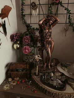 a table topped with lots of different types of jewelry and flowers on top of it