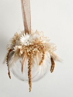 an ornament with feathers and flowers in it