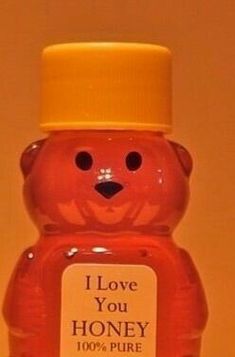 a bottle of honey with a small bear on it's head and label that says i love you honey 100 % pure