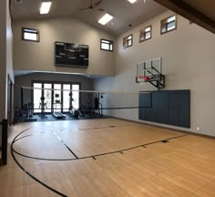 an indoor basketball court with hard wood flooring