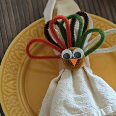 a turkey napkin holder on a yellow plate