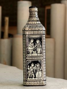 a decorative vase sitting on top of a table next to two smaller vases in the background