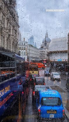 cars and buses on a city street in the rain