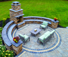 an outdoor patio with seating and fire place