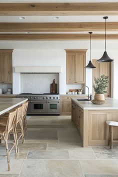 a kitchen with wooden cabinets and an island in the middle, surrounded by stone flooring