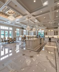 a large kitchen with marble floors and chandeliers