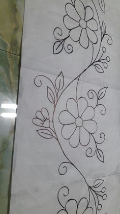 two flower designs on white paper with black ink