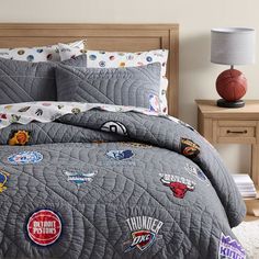 a bed with a basketball themed comforter and matching pillow shampoos on it