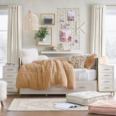 a bedroom with white furniture and gold accents