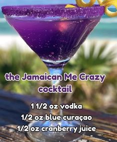 the jamaican me crazy cocktail is purple and has lemon garnish on it's rim